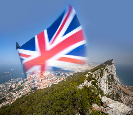 The Union Jack flag montaged onto The Rock of Gibraltar in the background, indicating the dispute over its sovereignty