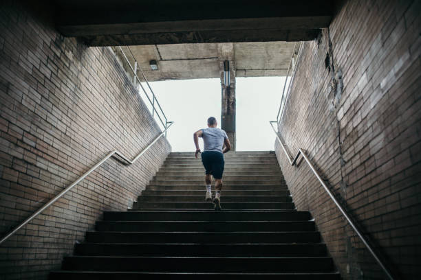 istock Young male athlete running up the stairs 1043676576