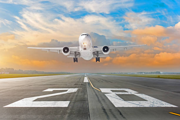 istock Airplane flying deperture landing speed motion on a runway in the evening during a bright red sunset. 1043676978