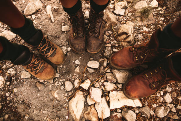 Hikers on rocky path wearing trekking boots