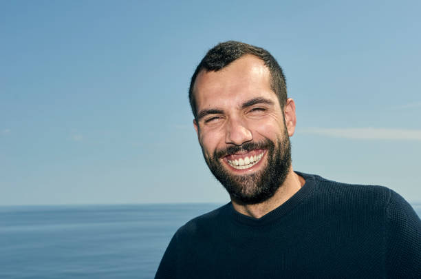istock Handsome man smiling on the deck of a ship during holidays. 1043677922