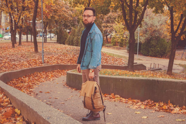 istock Attractive man posing in autumn park. 1043677978