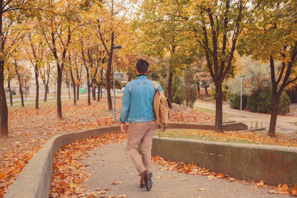 istock Attractive man posing in autumn park. 1043680914
