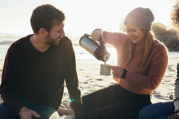 istock Smiling friends having coffee at the beach 1043681158