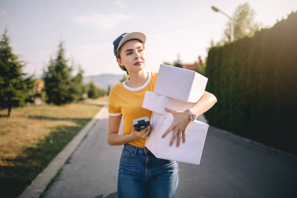 istock Lovely postal worker delivering packages 1043681188