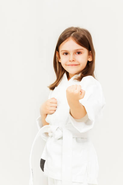 istock Little girl in white kimono training karate 1043682122