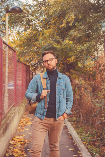 istock Attractive man posing in autumn park. 1043684560