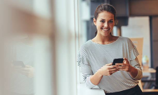 istock Businesswoman in office using a cell phone 1043685178