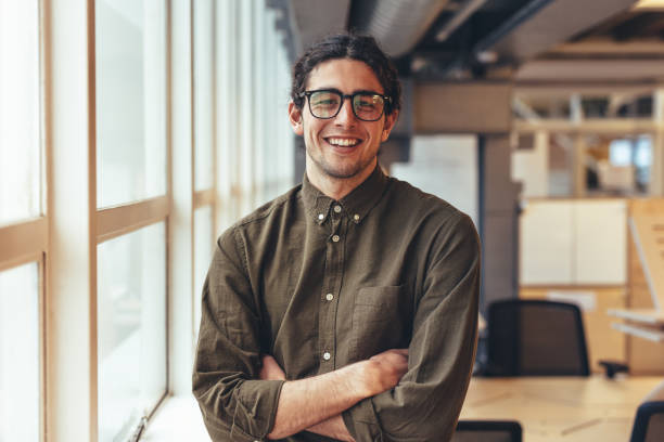 istock Happy businessman standing in office 1043685238
