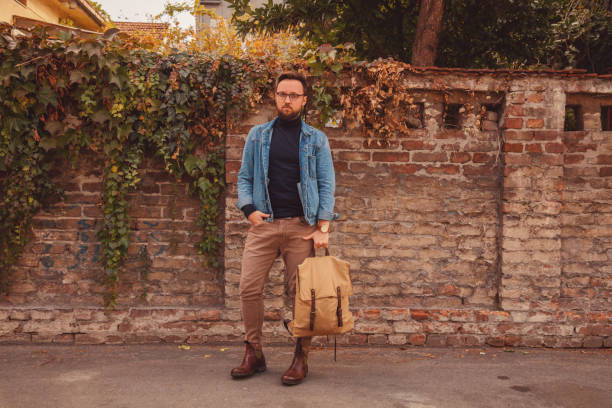 istock Attractive man posing on autumn street. 1043688854