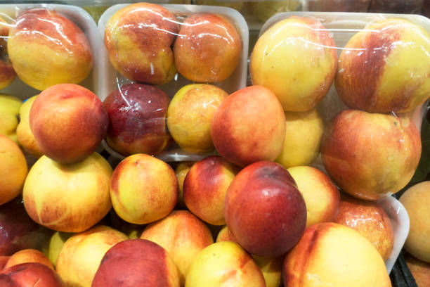 istock Fresh organic peaches in plastic packages 1043689208