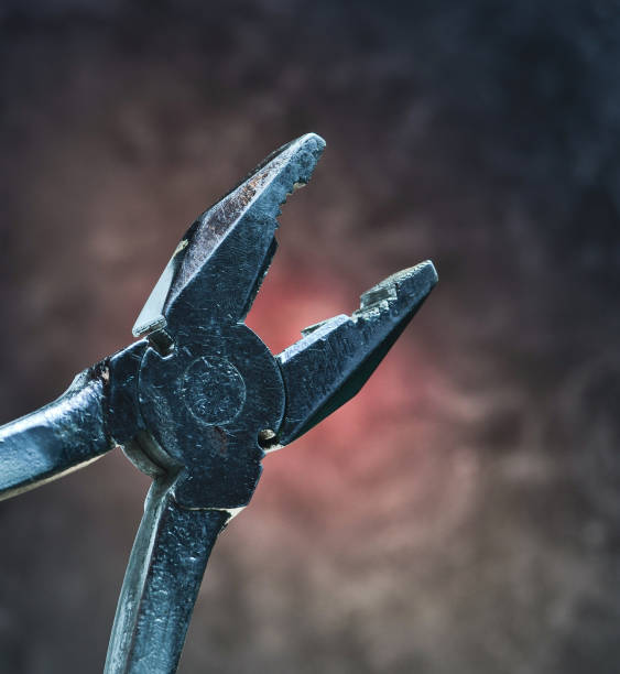 istock Pliers on the black concrete background 1043693688