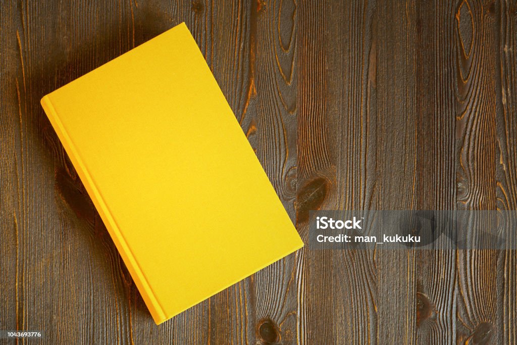 Libro giallo sul tavolo - Foto stock royalty-free di Libro