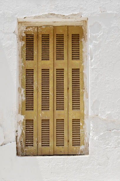 istock Abandoned stucco wall with closed window. 1043695236