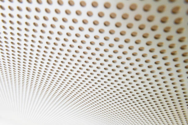 istock White metal plate with many small circular holes 1043695338
