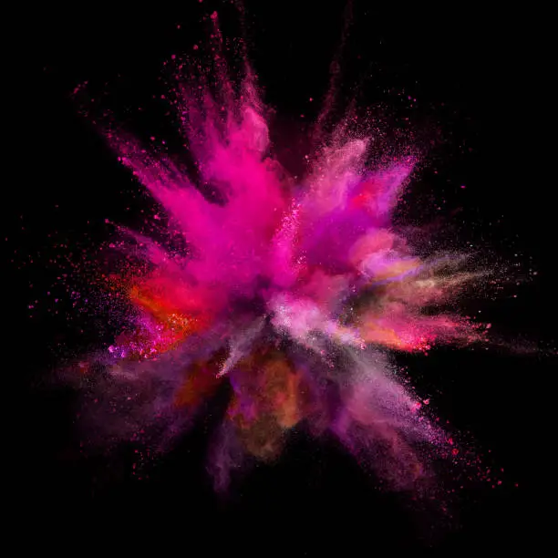 Photo of Colored powder explosion on black background.