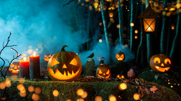 istock Halloween pumpkins on dark spooky forest. 1043700120