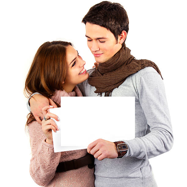 Attractive Couple Holding Blank Placard for Announcement stock photo