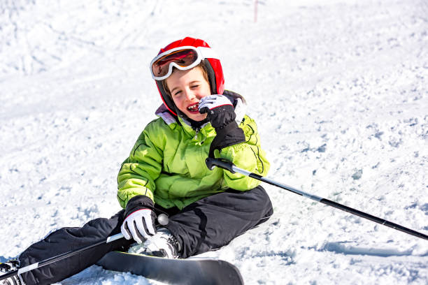 istock Child falling in the snow with skis 1043720134