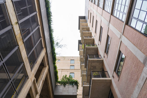 istock Low Angle View of three Residential Buildings Looking Upward 1043721362