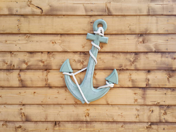 istock Nautical Anchor on Brown Wood Panel Wall 1043726038