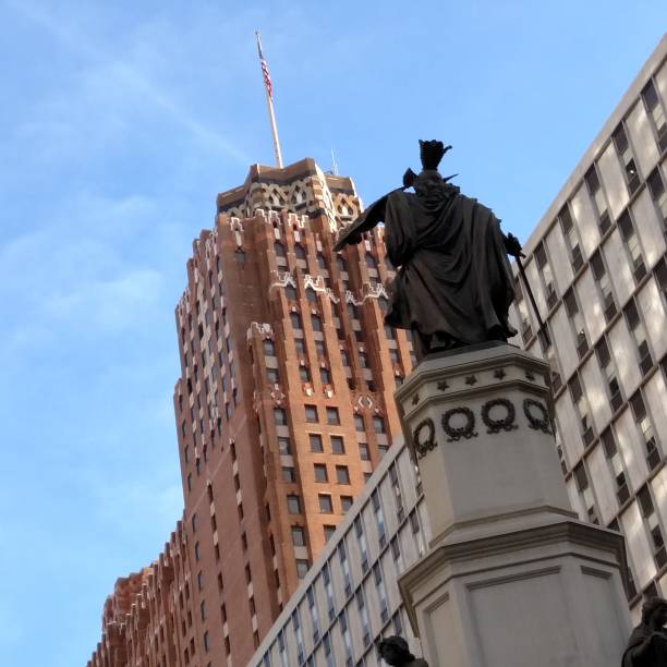istock statue in front of red brick skyscraper 1043730542