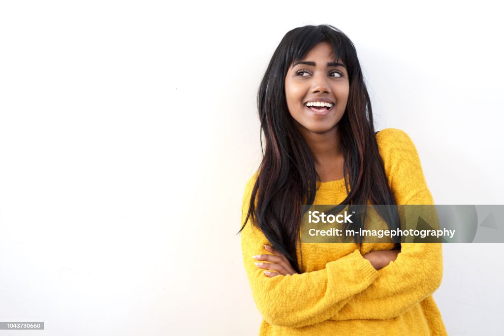 attractive young Indian woman smiling and glancing at copy space isolated white background Portrait of attractive young Indian woman smiling and glancing at copy space isolated white background White Background Stock Photo
