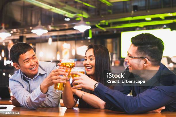 Group Of Happy Asian Friend Or Office Colleague Coworker Celebrate Toast Beer Pint Together At Pub Restaurant Or Night Club After Work Party Team Success Event Or Modern Friendship Lifestyle Concept Stock Photo - Download Image Now