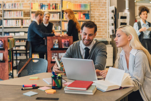 istock Couple of students in the library 1043733752