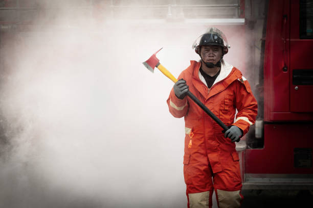 istock Firefighters training, Team practice to fighting with fire in emergency situation. A fireman run for help with axe 1043738484