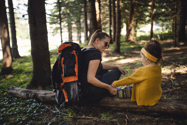 istock Mother and daughter drinking tea while taking a break from hiking 1043738532