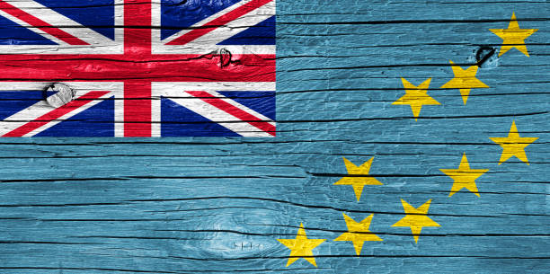 Close up grungy, damaged and weathered Tuvalu flag on wall peeling off paint to see inside surface.