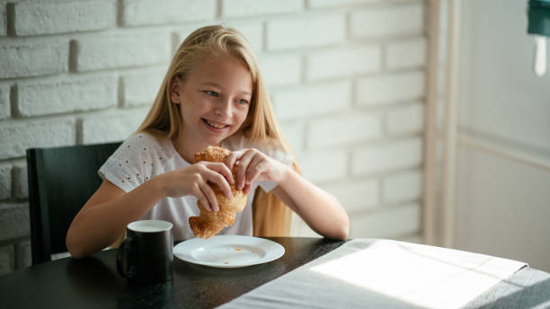 Young girl having breakfast at home