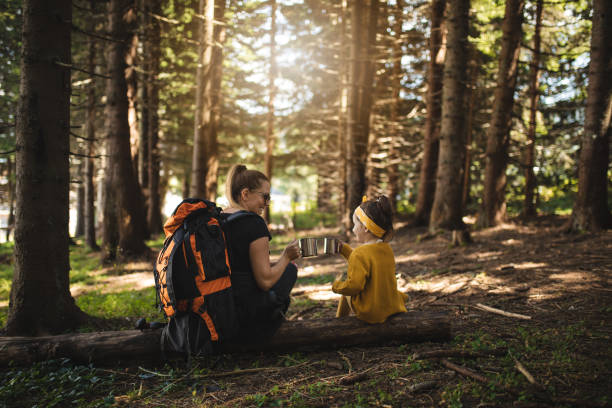 istock Lovely family of two drinking tea while taking a break from hiking 1043744346