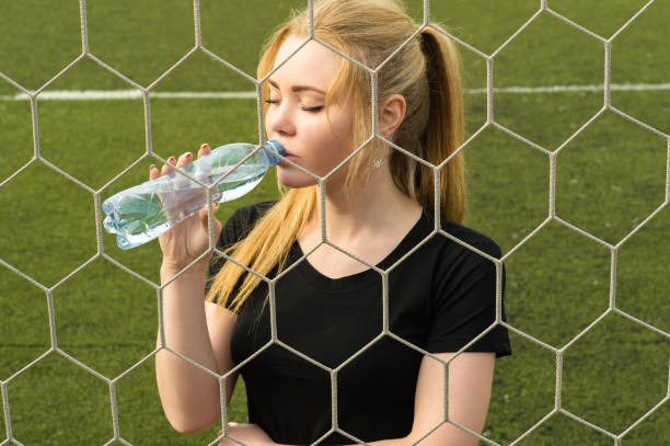 istock beautiful woman drinking water from bottle 1043744804