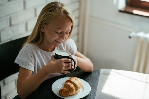 istock Young girl having breakfast at home 1043744832
