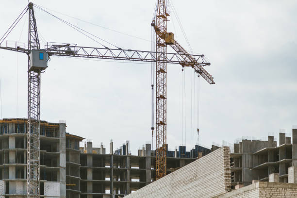 istock Lifting tower cranes on frame of frame building 1043751158