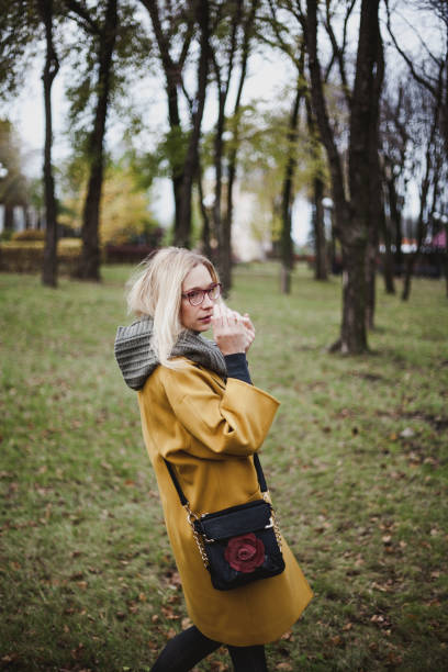 istock Cute blonde is walking in autumn park 1043752072