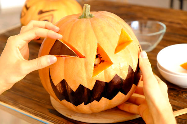 istock Halloween themed image with carved pumpkins in house party environment. 1043752700