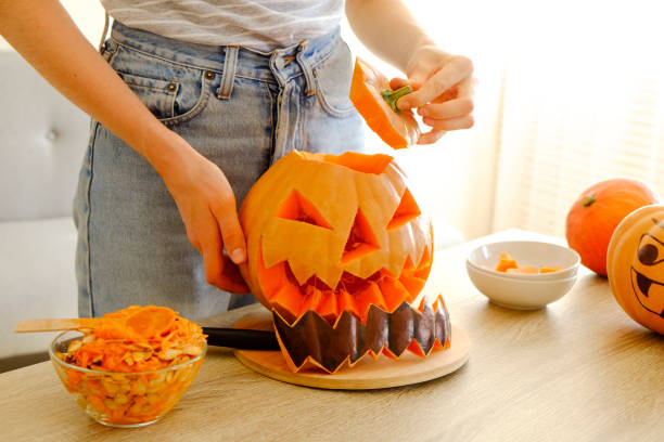istock Halloween themed image with carved pumpkins in house party environment. 1043752832