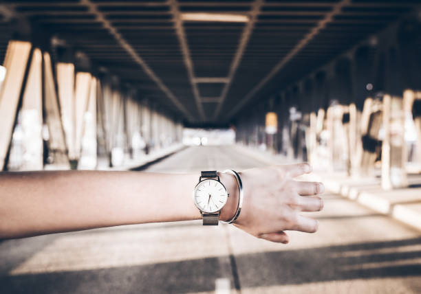 wristwatch and bracelet on female arm against city street woman checking time on wristwatch against city street wrist watch pov stock pictures, royalty-free photos & images