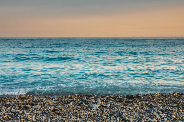 The Mediterranean sea and pebbles stones on a beach in Nice