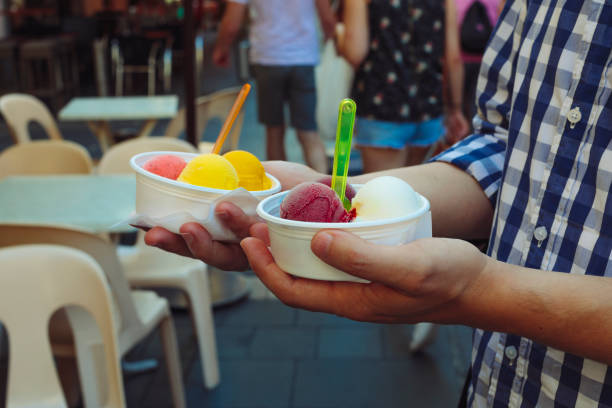 istock Young man holding ice cream bowls 1043759756