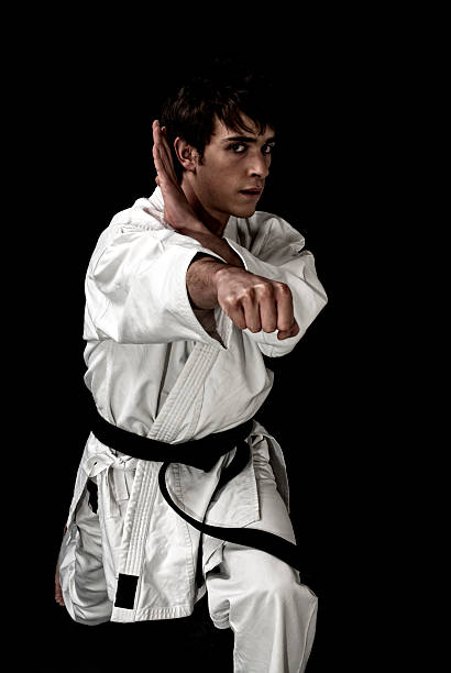 istock High Contrast karate male fighter on black background. 104376110