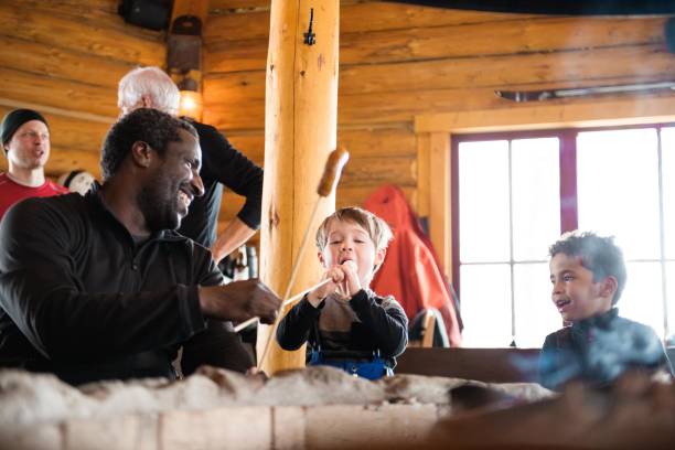 multi-ethnic family in a ski cottage, apres-ski break - apres ski winter friendship ski imagens e fotografias de stock