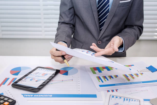 istock Businessman analyzing investment charts. 1043769566