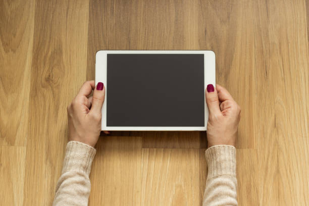 istock Girl lying on the floor holding a tablet 1043774196