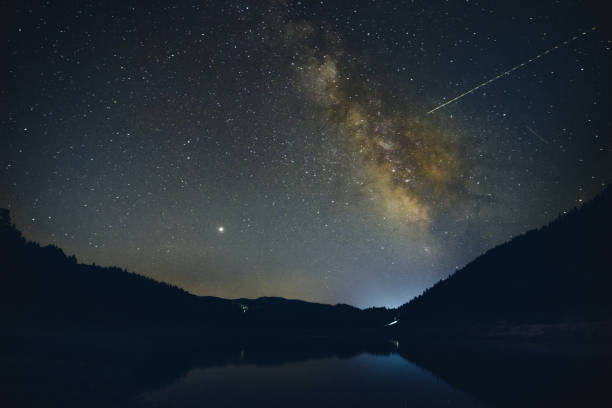 istock Starry sky with Milky Way over the mountain lake 1043774482