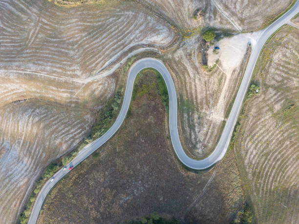 istock Road through farmland from above 1043775482