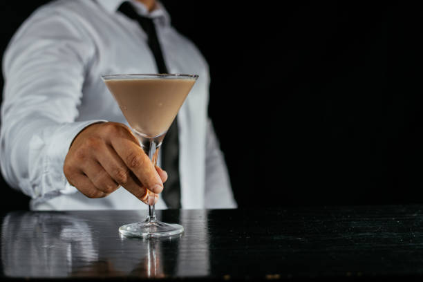 istock Barman preparing white cocktail in martini glass 1043778908